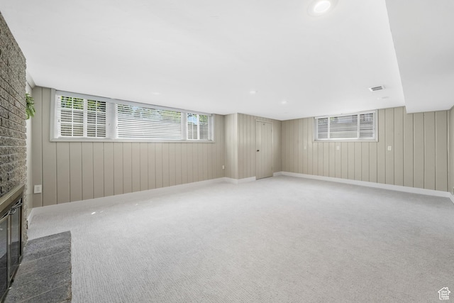 2612 S 1900 E, Salt Lake City, UT 84106 - unfurnished living room with carpet floors, a glass covered fireplace, and wood walls