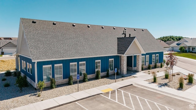 247 E 1850 N Unit 1, North Ogden, UT 84414 - back of house featuring uncovered parking, stone siding, a shingled roof, and board and batten siding