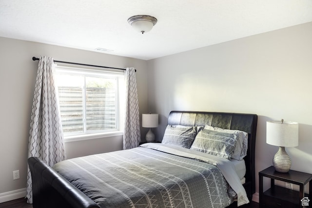 9788 S Dante Rd E, Sandy, UT 84092 - bedroom with baseboards and wood finished floors