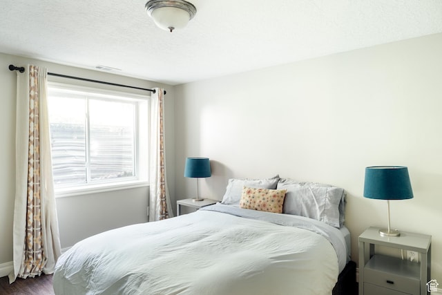 9788 S Dante Rd E, Sandy, UT 84092 - bedroom with dark wood-style flooring and a textured ceiling
