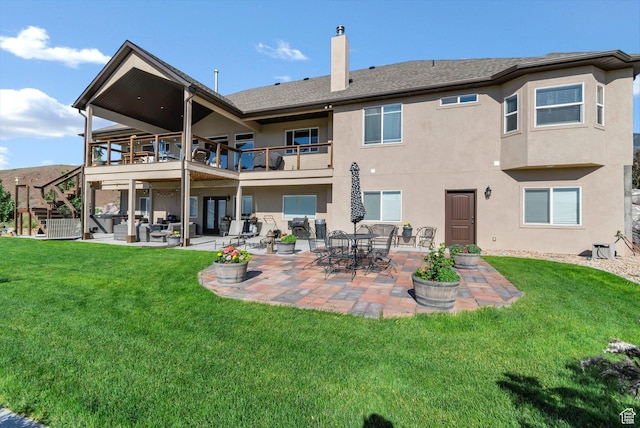 2253 N 1200 E, Monroe, UT 84754 - back of property featuring a chimney, stucco siding, a lawn, a patio area, and a balcony