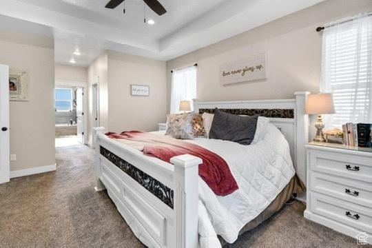 2253 N 1200 E, Monroe, UT 84754 - carpeted bedroom with multiple windows, ensuite bath, recessed lighting, a tray ceiling, and a ceiling fan