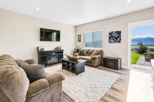2253 N 1200 E, Monroe, UT 84754 - living room featuring light wood-type flooring, healthy amount of natural light, recessed lighting, and a glass covered fireplace
