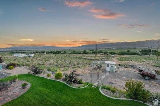 2253 N 1200 E, Monroe, UT 84754 - yard at dusk featuring a mountain view and a lawn