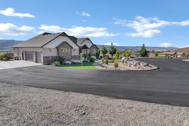 2253 N 1200 E, Monroe, UT 84754 - view of front facade featuring stone siding, asphalt driveway, a garage, and a mountain view