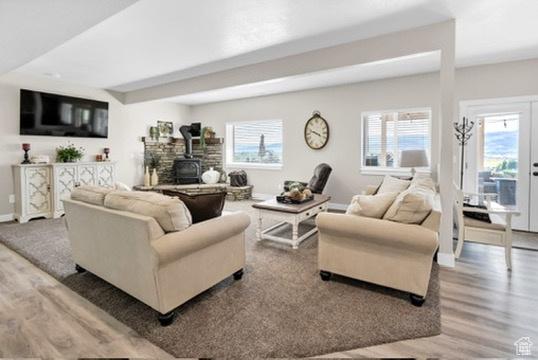 2253 N 1200 E, Monroe, UT 84754 - living area featuring wood finished floors, a wood stove, and healthy amount of natural light