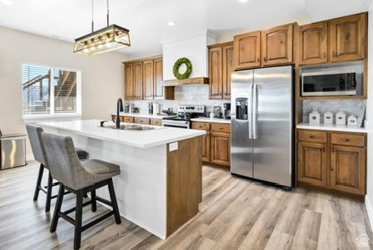 2253 N 1200 E, Monroe, UT 84754 - kitchen with appliances with stainless steel finishes, brown cabinets, tasteful backsplash, light wood-style floors, and recessed lighting