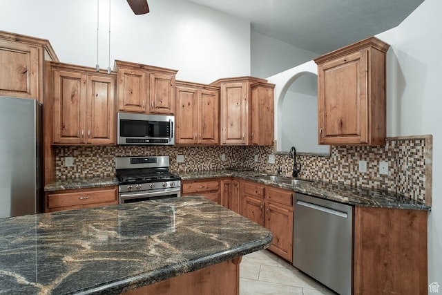 3524 S Price Hills Dr, St George, UT 84790 - kitchen with stainless steel appliances, brown cabinets, decorative backsplash, and high vaulted ceiling