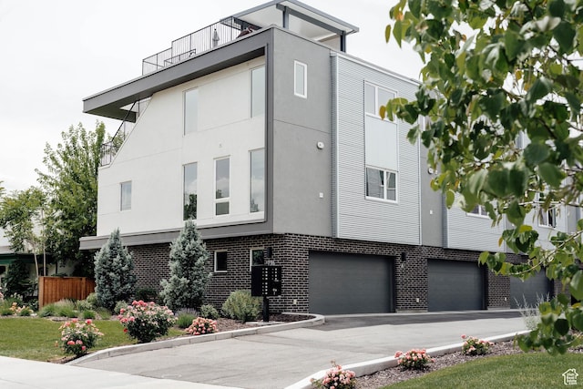 736 S 300 E Unit 1A, Salt Lake City, UT 84111 - view of front of house with stucco siding, an attached garage, and brick siding