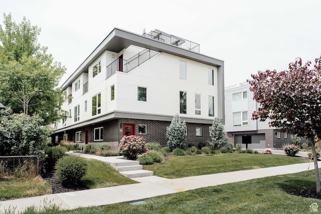 736 S 300 E Unit 1A, Salt Lake City, UT 84111 - view of front of property with stucco siding, a front yard, and brick siding
