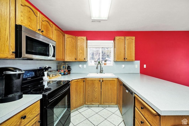 162 W 1275 S Unit 162, Logan, UT 84321 - kitchen featuring stainless steel appliances, light countertops, a peninsula, and brown cabinetry