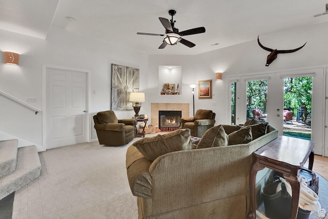1269 Alice Ln, Farmington, UT 84025 - living area featuring a tiled fireplace, stairs, a ceiling fan, and light carpet