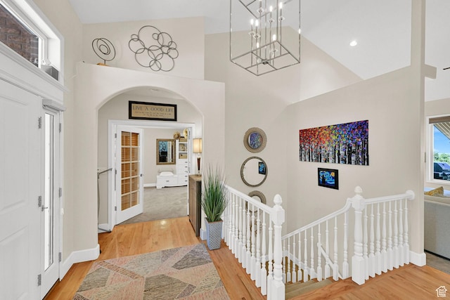1269 Alice Ln, Farmington, UT 84025 - foyer entrance featuring a high ceiling, light wood-style floors, a chandelier, and arched walkways