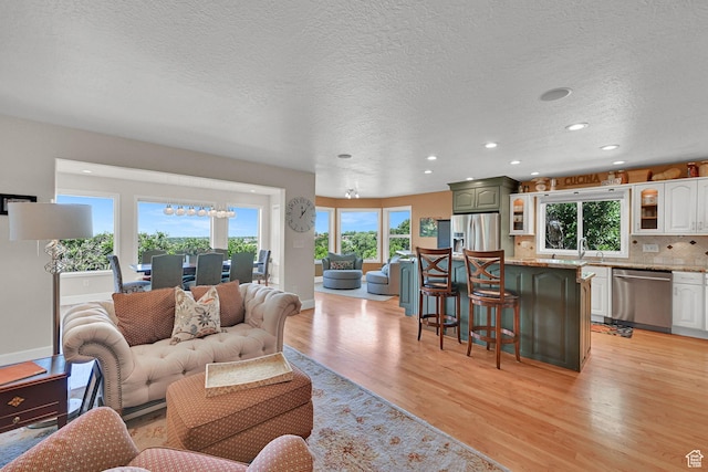 1269 Alice Ln, Farmington, UT 84025 - living room with light wood-style floors, healthy amount of natural light, recessed lighting, and a textured ceiling