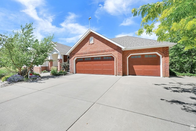 1269 Alice Ln, Farmington, UT 84025 - view of front of house with brick siding, a garage, driveway, and roof with shingles
