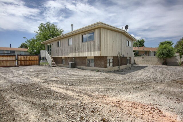 2266 W Arches Dr, Taylorsville, UT 84129 - rear view of house featuring a fenced backyard and stairway