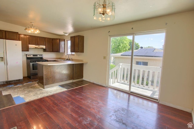 2266 W Arches Dr, Taylorsville, UT 84129 - kitchen featuring white fridge with ice dispenser, stainless steel electric range, a chandelier, under cabinet range hood, and dark wood-style flooring