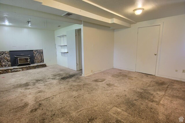 2266 W Arches Dr, Taylorsville, UT 84129 - unfurnished living room featuring carpet floors and a wood stove
