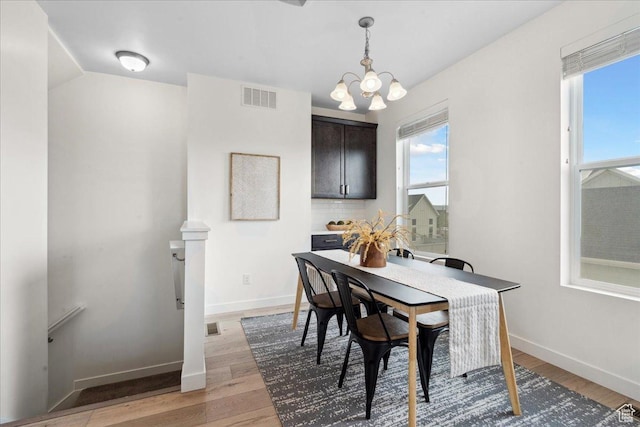 5504 W Burntside Ave, South Jordan, UT 84009 - dining space featuring a chandelier and light wood-type flooring
