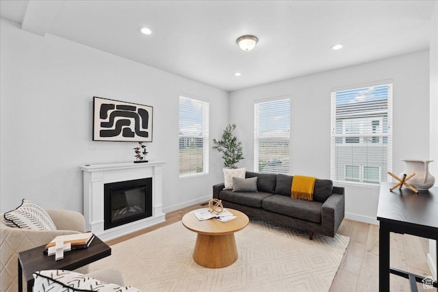 5504 W Burntside Ave, South Jordan, UT 84009 - living room featuring light wood-style flooring, recessed lighting, and a glass covered fireplace