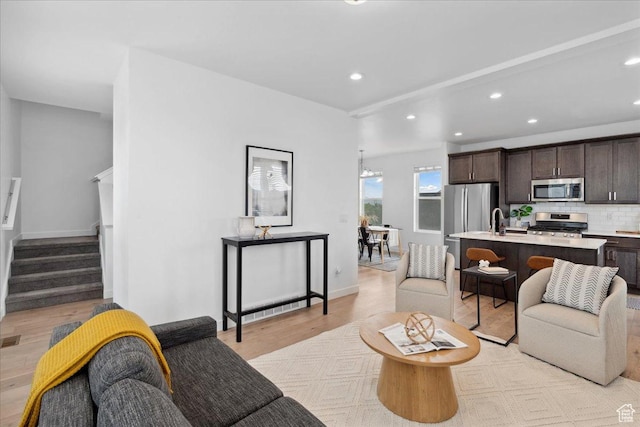5504 W Burntside Ave, South Jordan, UT 84009 - living room with light wood-style flooring, recessed lighting, and stairs