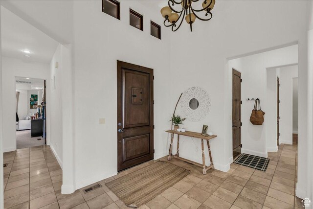 1683 W Red Cloud Dr, St George, UT 84770 - foyer entrance with a chandelier, light tile patterned flooring, and a towering ceiling