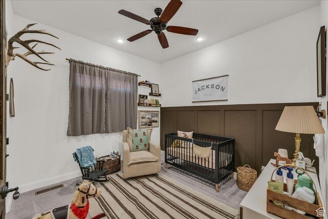1683 W Red Cloud Dr, St George, UT 84770 - living area with a decorative wall, ceiling fan, recessed lighting, light colored carpet, and a wainscoted wall