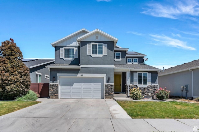 123 E 460 N, Vineyard, UT 84059 - view of front of house with concrete driveway, a garage, roof mounted solar panels, and stone siding