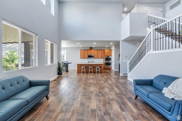 123 E 460 N, Vineyard, UT 84059 - living room with a high ceiling, stairs, dark wood-style floors, and plenty of natural light
