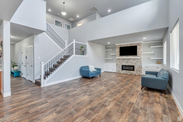 123 E 460 N, Vineyard, UT 84059 - living room featuring wood finished floors, stairs, a towering ceiling, a stone fireplace, and recessed lighting