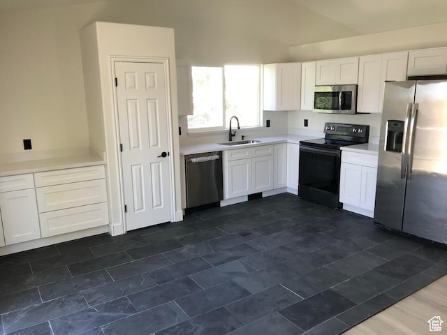 6116 W Graceland Way, West Jordan, UT 84081 - kitchen featuring appliances with stainless steel finishes, white cabinetry, light countertops, and high vaulted ceiling