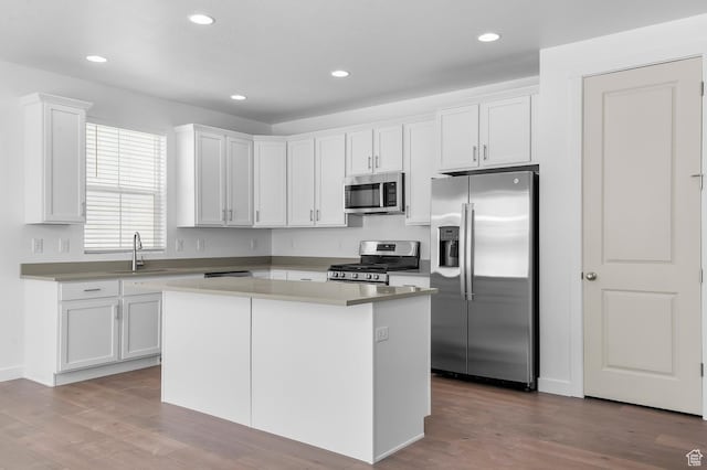 1881 E Moho Mtn, Eagle Mountain, UT 84005 - kitchen featuring stainless steel appliances, white cabinets, wood finished floors, a center island, and recessed lighting