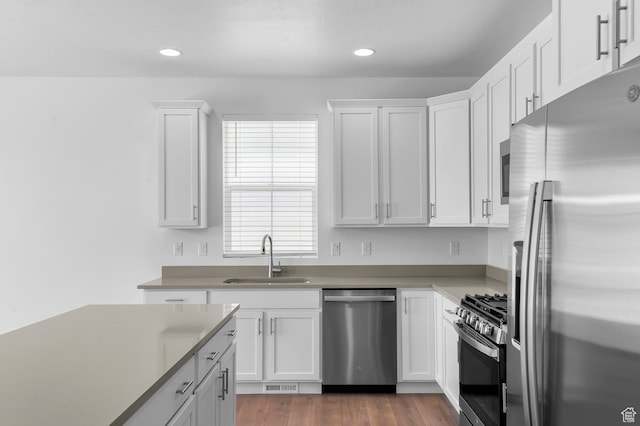 1881 E Moho Mtn, Eagle Mountain, UT 84005 - kitchen with stainless steel appliances, white cabinets, recessed lighting, wood finished floors, and light countertops