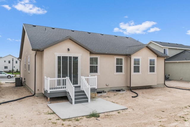 1881 E Moho Mtn, Eagle Mountain, UT 84005 - back of property with a patio, a deck, stucco siding, and roof with shingles