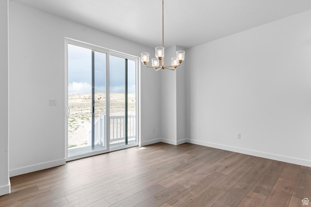 1881 E Moho Mtn, Eagle Mountain, UT 84005 - unfurnished room featuring a chandelier, wood finished floors, and healthy amount of natural light