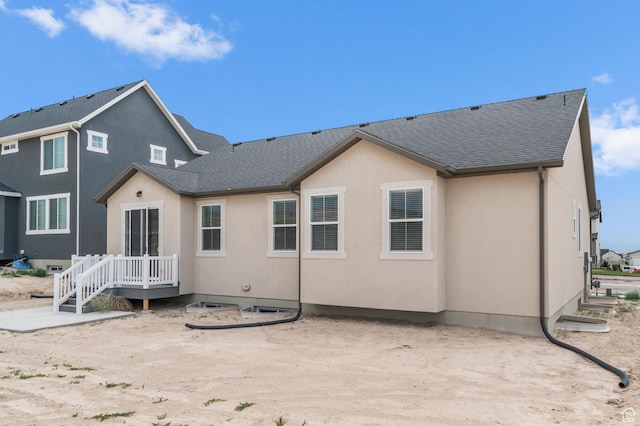 1881 E Moho Mtn, Eagle Mountain, UT 84005 - rear view of property featuring roof with shingles, stucco siding, and a wooden deck