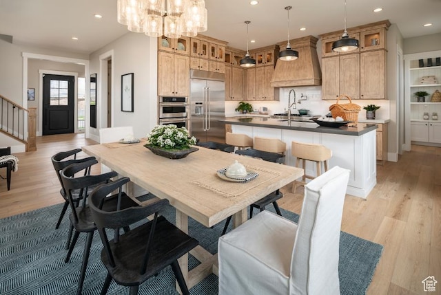 4583 N Solstice Dr Unit 301, Lehi, UT 84043 - dining space with light wood finished floors, recessed lighting, a chandelier, and stairs