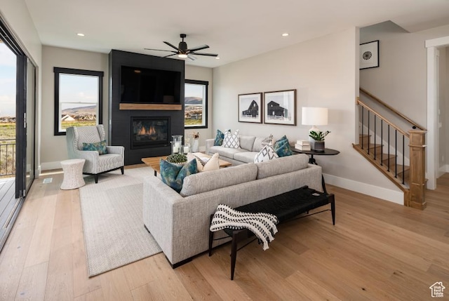 4583 N Solstice Dr Unit 301, Lehi, UT 84043 - living room featuring light wood-style flooring, ceiling fan, recessed lighting, stairs, and a large fireplace