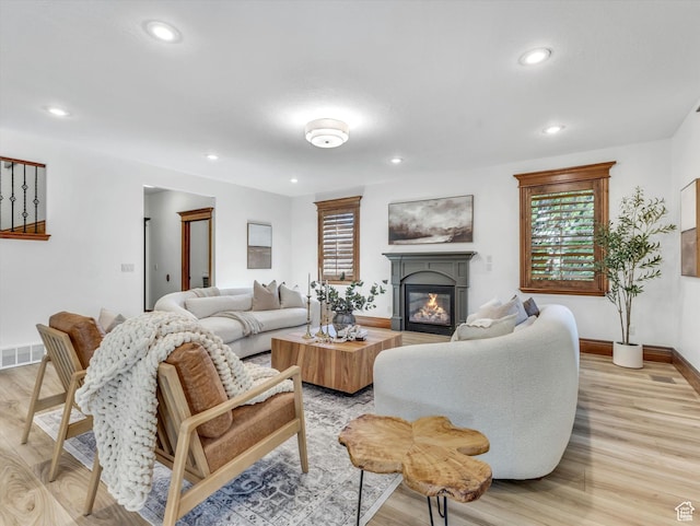 6037 Chamberry Way N, Highland, UT 84003 - living room featuring light wood-style floors, a glass covered fireplace, and recessed lighting