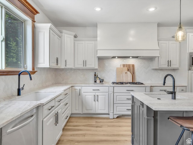 6037 Chamberry Way N, Highland, UT 84003 - kitchen featuring custom range hood, stainless steel appliances, white cabinets, hanging light fixtures, and light stone counters