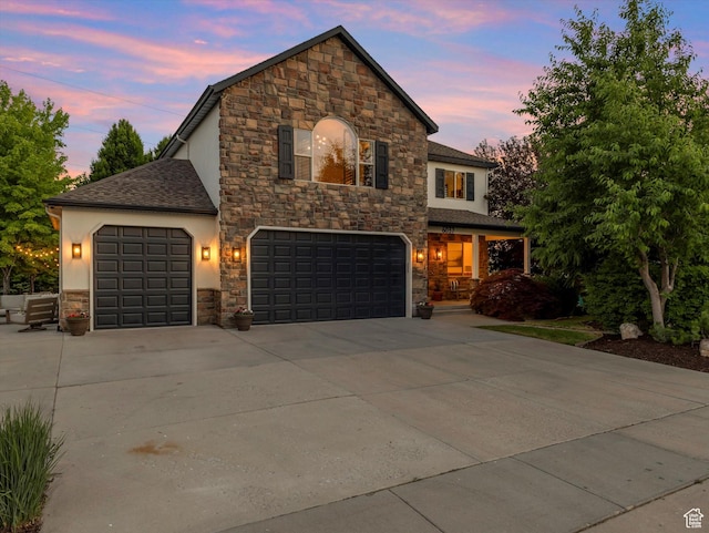 6037 Chamberry Way N, Highland, UT 84003 - view of front facade featuring stone siding, concrete driveway, stucco siding, and a shingled roof
