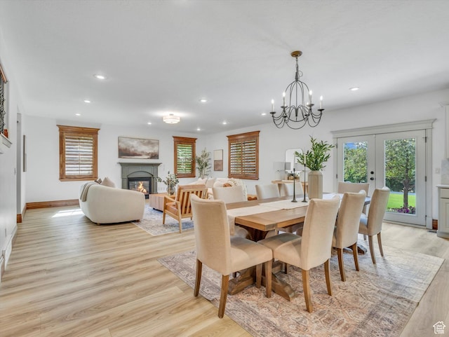 6037 Chamberry Way N, Highland, UT 84003 - dining room featuring light wood-type flooring, recessed lighting, french doors, a glass covered fireplace, and a chandelier