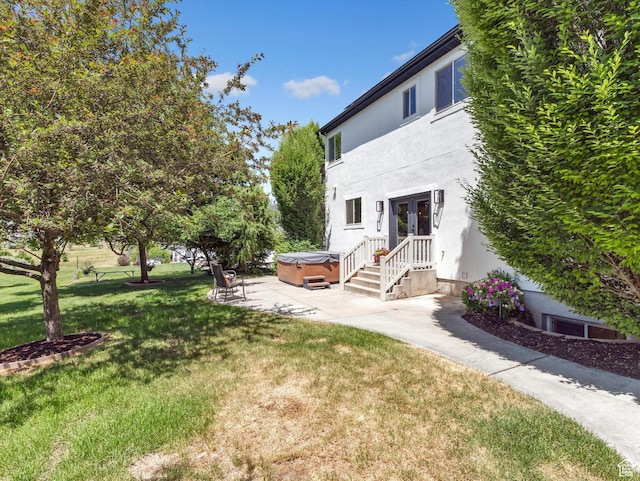 6037 Chamberry Way N, Highland, UT 84003 - view of grassy yard featuring a hot tub, french doors, and a patio area