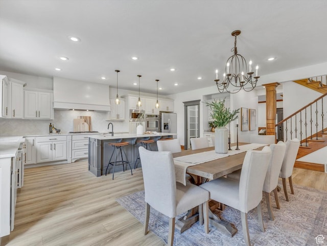 6037 Chamberry Way N, Highland, UT 84003 - dining room with light wood-style floors, stairs, a chandelier, and recessed lighting