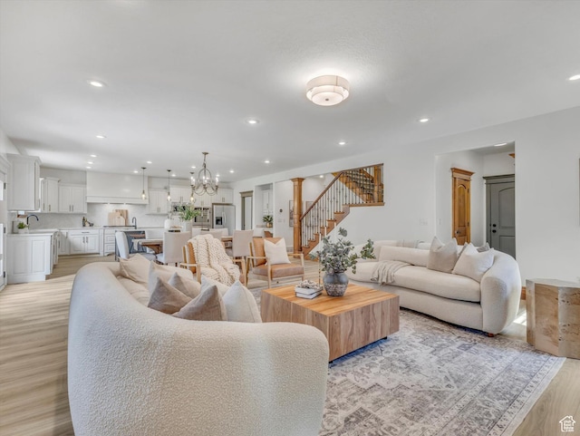 6037 Chamberry Way N, Highland, UT 84003 - living area featuring stairs, recessed lighting, light wood finished floors, and a chandelier