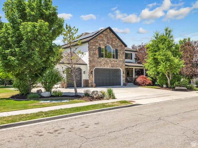6037 Chamberry Way N, Highland, UT 84003 - traditional-style house with stone siding, an attached garage, concrete driveway, and solar panels