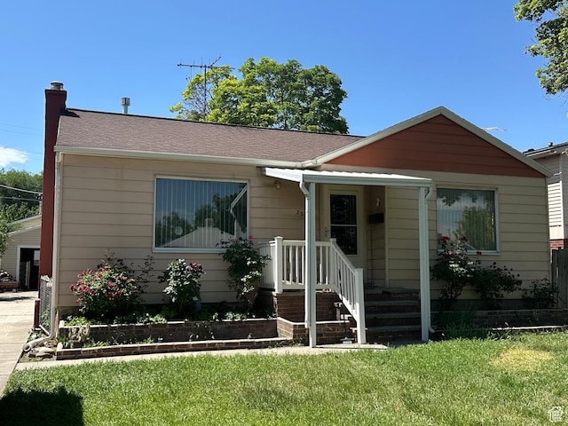 250 E Beryl, South Salt Lake, UT 84115 - view of front of house with a front yard, a chimney, and a shingled roof