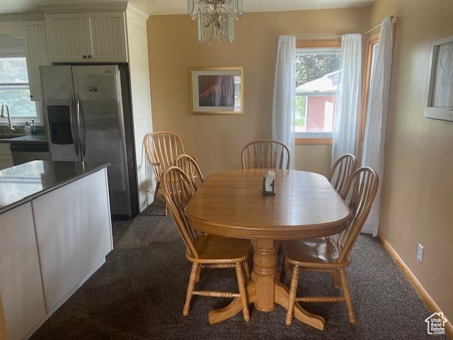 535 W 500 N, Malad City, ID 83252 - dining room featuring dark colored carpet and a chandelier