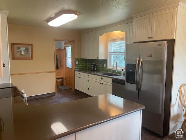 535 W 500 N, Malad City, ID 83252 - kitchen with appliances with stainless steel finishes, healthy amount of natural light, tasteful backsplash, and white cabinets