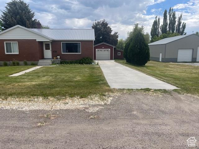 535 W 500 N, Malad City, ID 83252 - ranch-style house featuring driveway, an outbuilding, a front yard, a garage, and a chimney